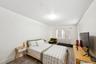 Bedroom with wood finished floors and baseboards