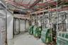 Utility room featuring multiple water heaters and boiler systems