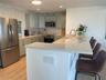 The thoughtfully designed kitchen has quartz counter tops, solid wood cabinets and an endless view.