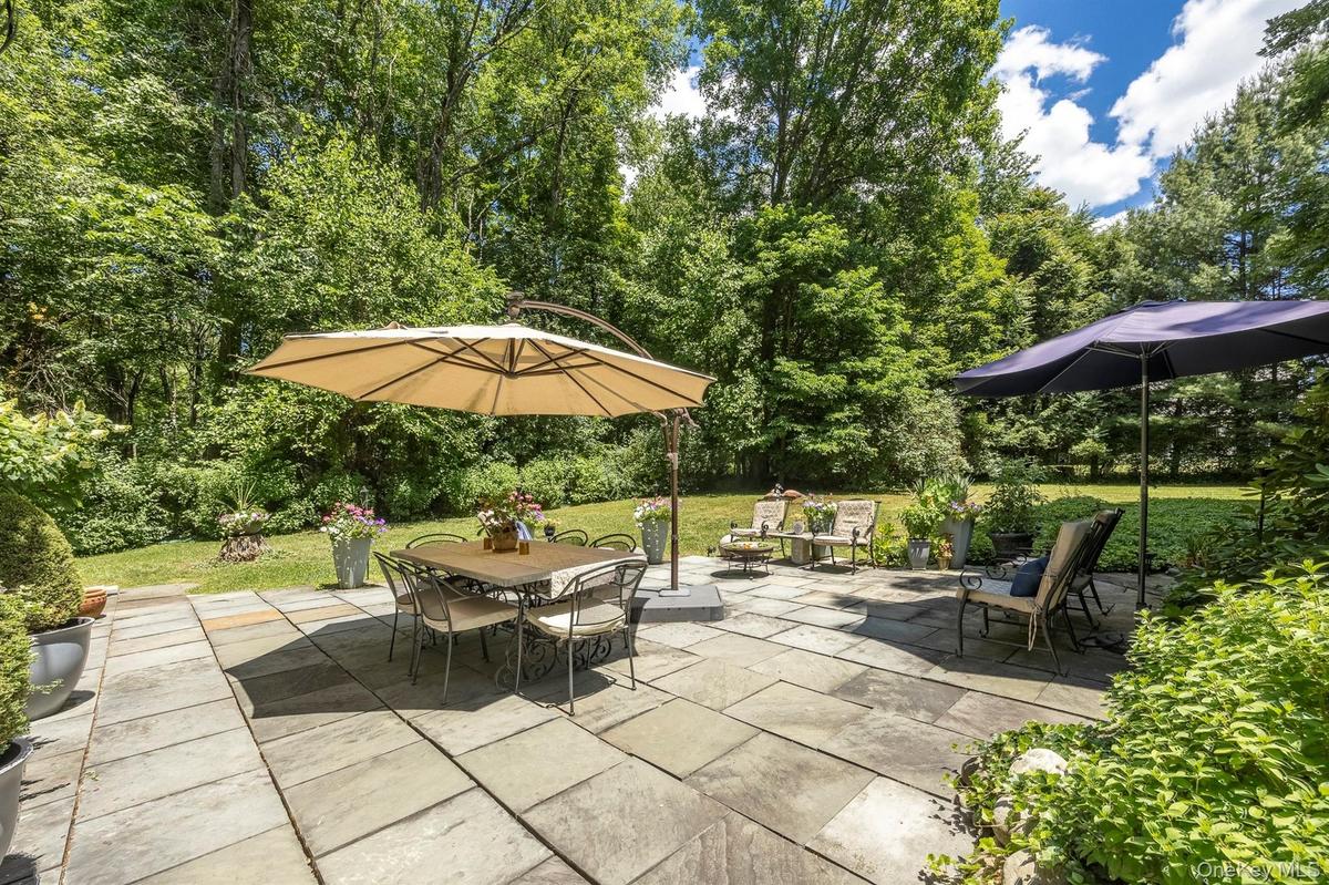 Sit on the beautiful patio and enjoy the view of the spacious backyard