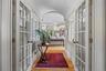 An elegant hallway leads from the foyer into the newer addition
