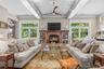 The great room/family room has a fireplace, high ceilings & two sets of French doors out to the stone patio & back yard
