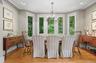 A charming formal dining area with a wall of windows is part of the open floor plan