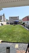 Expansive green lawn with a gravel border and integrated fire pit