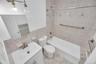 Bathroom featuring a white vanity with a basin sink, brushed nickel faucet, and a wall-mounted mirror