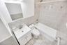 Bathroom featuring a white vanity with a basin sink, chrome faucet, and integrated storage