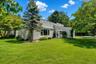 Home surrounded by mature landscaping