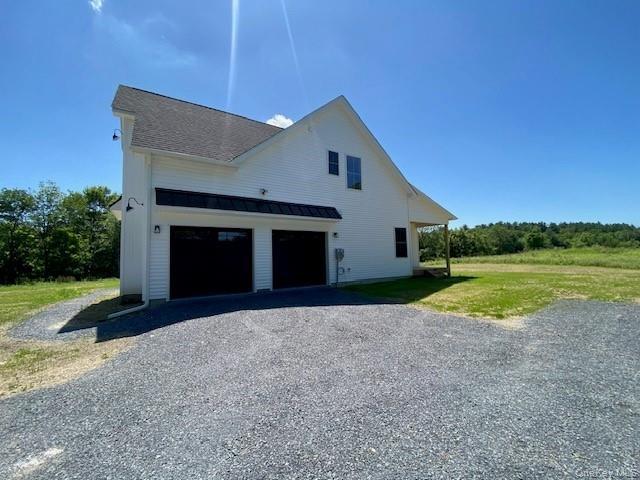 The expansive driveway offers generous parking while the side-entry garage contributes to the home's architectural design. The attached garage offers 