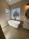 A large free standing soaking tub creates a relaxing sanctuary designed for comfort and tranquility.