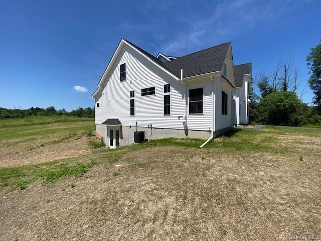 This impressive side view showcases the home’s generous yard, expansive outdoor space, and peaceful surroundings, offering a rare combination of priva