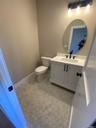 Elegant lighting, a custom vanity, and stylish finishes create a warm and welcoming space, thoughtfully designed to complement the home’s timeless aes