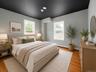 1 of the 5 bedrooms. Located on the main level. This is digitally enhanced to show how it would look with furniture.
