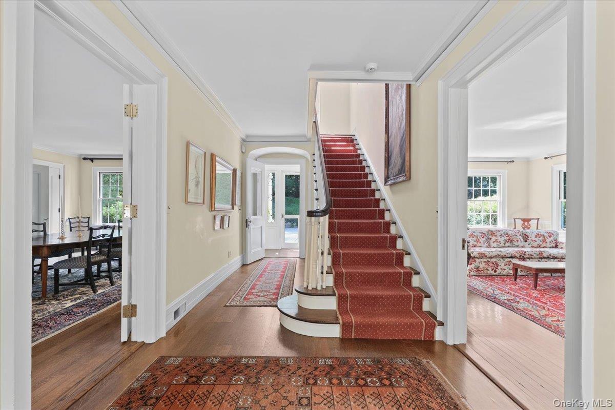 Magnificent front staircase, landing opens to the living room and the dining room
