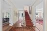 Magnificent front staircase, landing opens to the living room and the dining room