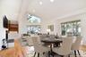 Virtually staged Living/Dining area with high vaulted ceiling, light wood flooring, recessed lighting, and a fireplace