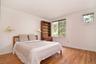 Large second Bedroom with light wood finished floors and 2 closets