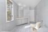 Primary full bath featuring tile walls, light tile patterned floors, recessed lighting, and vanity