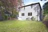Rear view of property with a patio area and a lawn