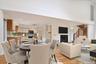 Virtually stagedDining area with vaulted ceiling, light wood floors, a fireplace and recessed lighting