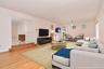 Virtually staged 30' Great Room with wall space for large TV and light wood finished floors