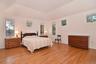 Bedroom featuring tray ceiling and 4 closets