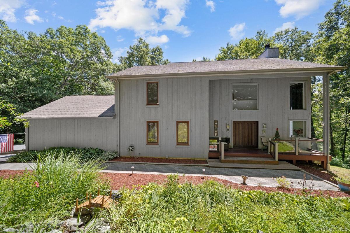Riverside retreat offering three levels of exquisitely designed living space, blending comfort, style, and the beauty of its serene natural surroundin