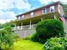 Great Colonial offers a covered rocking-chair porch, spacious LR, FR with fireplace, Primary BR & Full Bath.