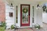 Covered side door entrance with delightful porch overlooks the side/front yard.