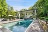 Back of property with a patio, stucco siding, and a chimney