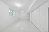 Bright, open room featuring polished light-toned flooring, pristine white walls, and recessed ceiling lighting