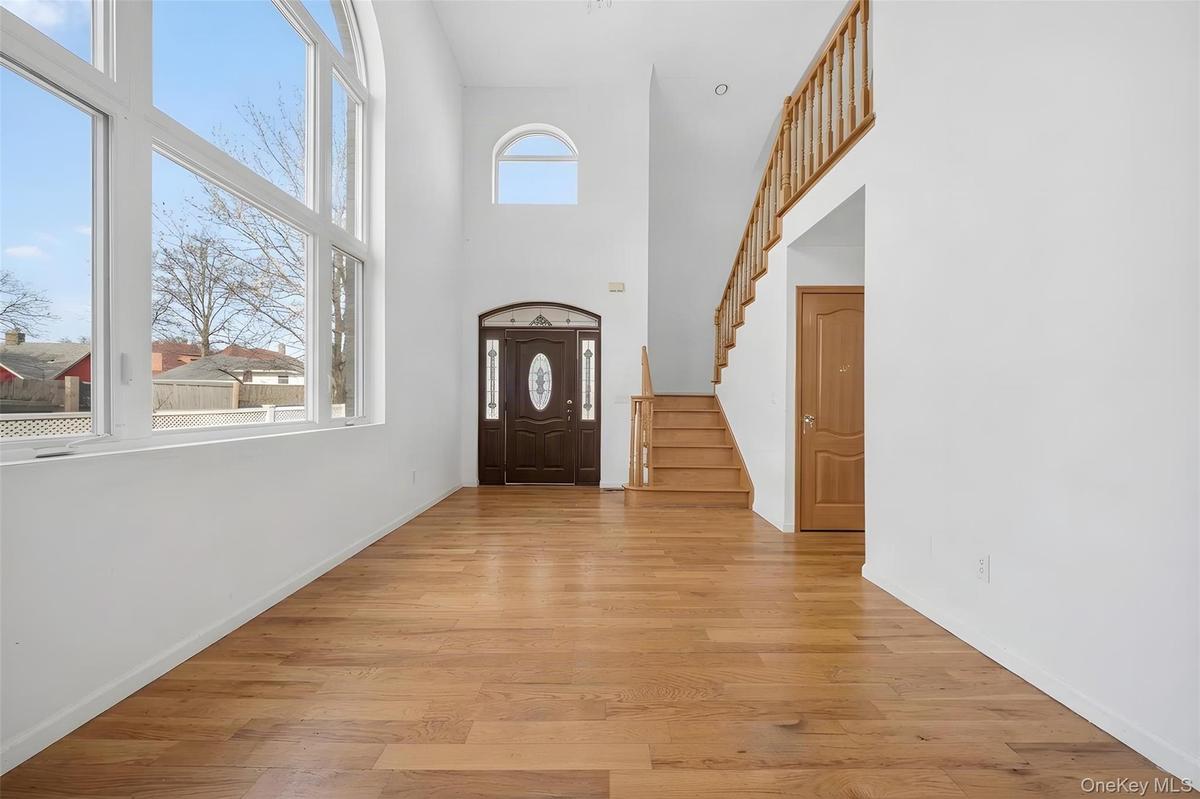 Double-height entryway with an arched transom window