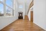 Double-height entryway with an arched transom window