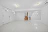 Spacious finished basement featuring polished concrete flooring, recessed ceiling lighting, and multiple egress windows