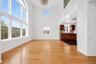 Expansive living area with soaring ceilings and light wood-finish flooring