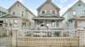 View of front of house with covered porch and a fenced front yard