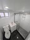Bathroom featuring a shower stall, vanity, visible vents, toilet, and marble finish floor