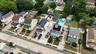 Aerial perspective of a residential neighborhood featuring multiple detached homes with varying architectural styles