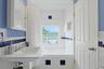 The adjoining bath also has an entrance from the hall and serves the third bedroom across the hall, with serene lake views, bringing beauty and a sens