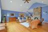 The spacious and inviting living room features a stunning stone fireplace. Pour yourself a drink at the bar, cozy up to the fireplace on autumn and wi
