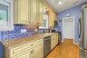 Custom tiles in kitchen made by Rosanne Breuer, Master Potter.