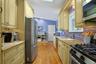 A beautifully appointed chef's kitchen featuring stainless steel appliances: 4 ovens including a range with upper and lower oven, a Trivection oven, a