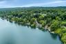 Much of the Kirk Lake shoreline property across from this home is not buildable, assuring quiet enjoyment fo years to come