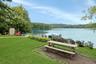 Enjoy outdoor dining by the water's edge, where peaceful lake views create the perfect backdrop. The few neighboring homes are set back, with no one t