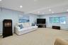 On the lower level, the spacious family room also offers beautiful lake views, creating the perfect place to relax, gather, and enjoy the scenery.