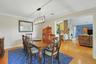 The dining room flows seamlessly into both the living room and kitchen, creating an open, inviting space