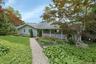 A welcoming walkway leads to your lake life dreams come true. With blooming perennials  offering beautiful curb appeal and a warm first impression, it