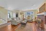 Living area featuring stairs, light wood finished floors, a fireplace, and recessed lighting