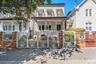 This beautiful multi-level home stands out with its eye-catching white iron gates, classic brick pillars, and a welcoming front porch. Shaded by matur