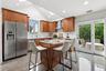 Fabulous eat-in-kitchen with vaulted, skylit ceiling and sliders to the patio