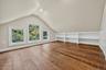 Hardwood-finish flooring, built-in shelving, white trim windows, sloped ceiling, recessed lighting